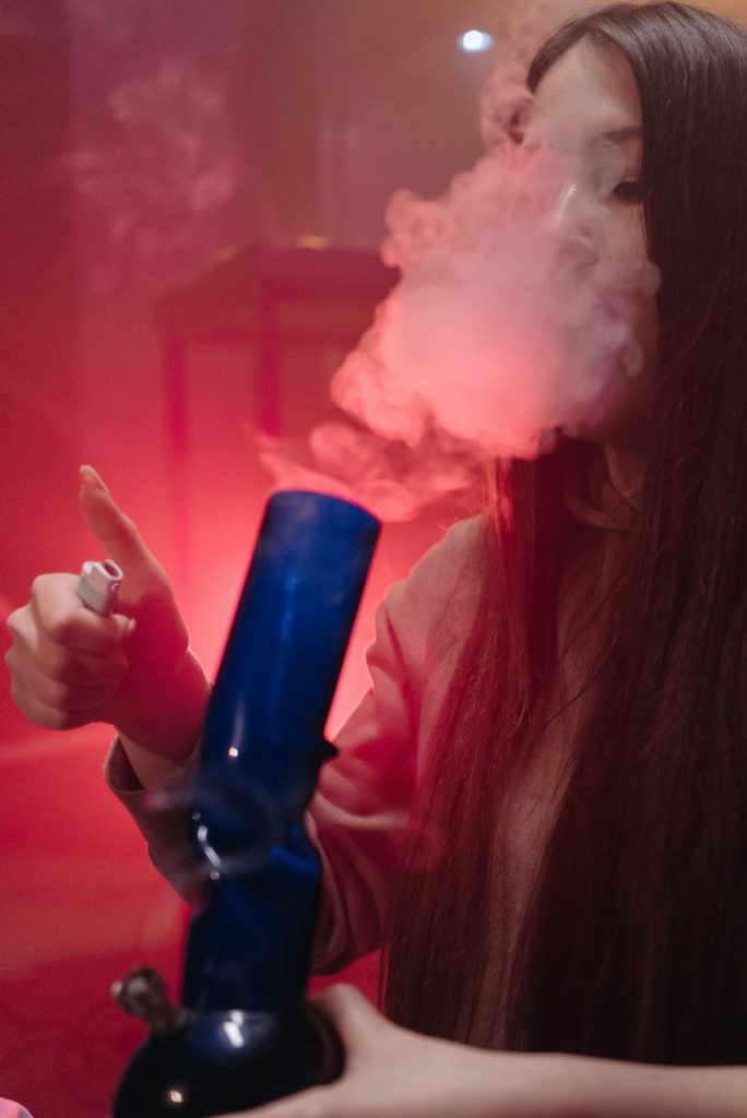 a woman smoking with a bong